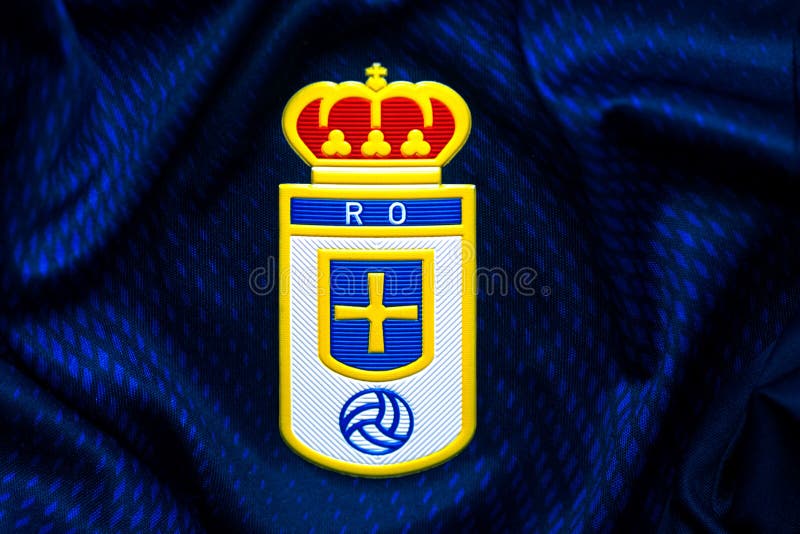 Closeup Of Real Oviedo Football Club Crest On The Sports Shirt Closeup Of Real Oviedo Football Club Crest On The Sports Shirt